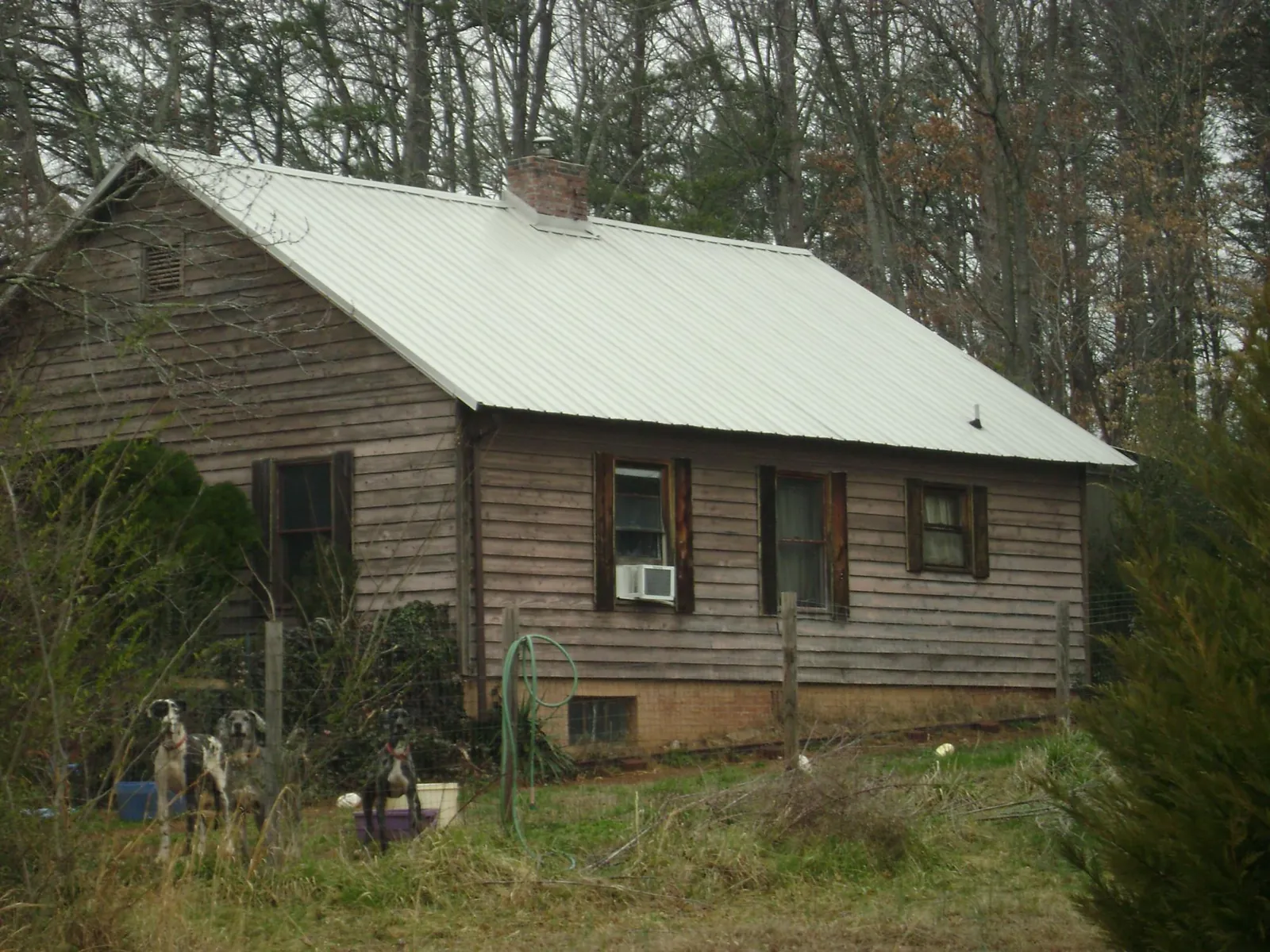White metal roof on an old wood sided farmhouse, from a Metal Roof Installation job in Fort Cobb